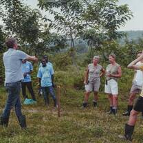 A group of volunteers receiving an introduction to the food forest