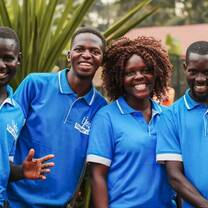 Ugandan staff members smiling into the camera