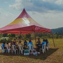 Staff members and volunteers in a meeting outside 