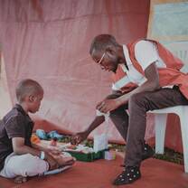 Volunteer playing with little boy