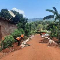 Staff members and volunteers working on road surrounding fun village