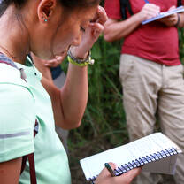 Students make observations in the field study notebook
