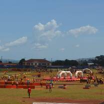 Open field with play items and kids running around