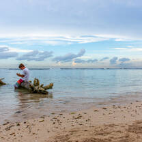 VISIONS Dominican Republic participant journaling at the beach