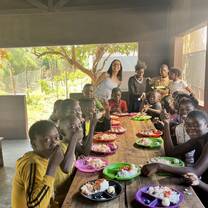 Volunteer and children during lunch time. 