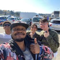 Two volunteers and two of the coordinator team give the camera a thumbs up!