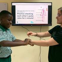 Child learning how to check pulse