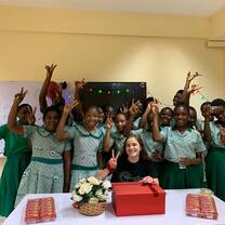 Group photo with volunteer in classroom