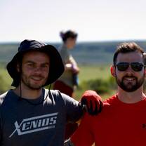 two volunteers pose for a photo