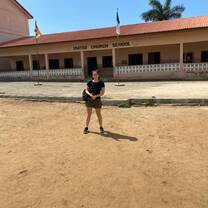 Volunteer in front of United Church School