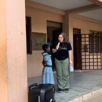 Volunteer addressing a child