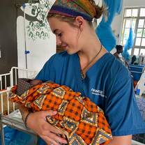 Doctor carrying new born baby