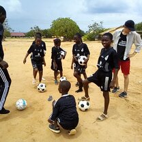 Volunteers helping with football coaching