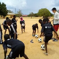 Volunteers assisting local coaches during soccer sessions