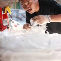 Preparing to compress plastic waste using a self-made machine