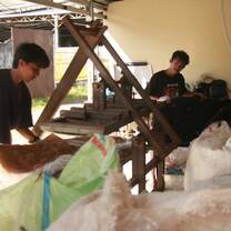 Compressing plastic waste using a self-made machine.