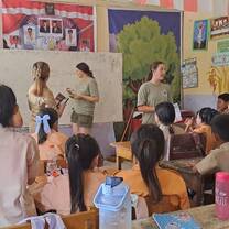 Learning session in a school classroom with children facilitated by volunteers
