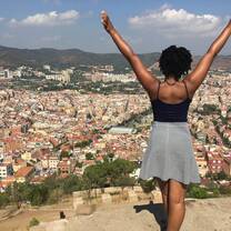 AIFS Abroad participant with her arms up with the background of Barcelona