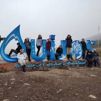 Students in Front of Quijos Sign