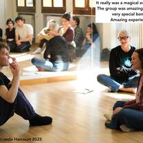 Miranda Harcourt seated with students