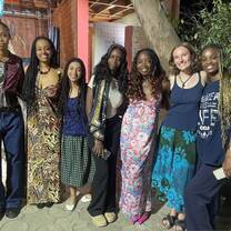 6 smiling students in traditional west african tissues and dress in Dakar, Senegal. 