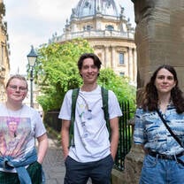 Three students in front of the Radcliffe Camera in Oxford