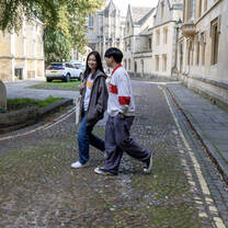 Two students walking on historic cobble stone streets