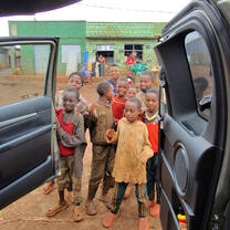 the children are welcoming  their teacher 