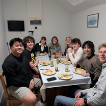 Students having a meal together in their apartment