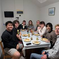 Students having a meal together in their apartment