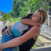 blonde woman hugging child