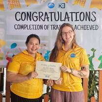 Teacher Millie an international teacher at KET HQ in Sukhothai holding her graduation certificates.