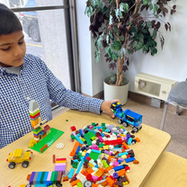 A student engaging in creative play through the art program