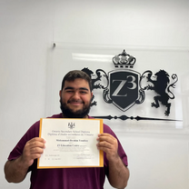A graduating high school student holding a OSSD diploma from Z3 Education Centre