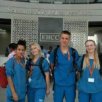 Group of medical interns in blue scrubs standing inside EHCC Hospital in Jaipur, India.