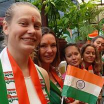 Group of AIP interns smiling and holding Indian flags while celebrating Independence Day in Jaipur.
