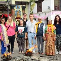 Interns and locals standing in front of a temple during a fire ritual ceremony in Nepal.