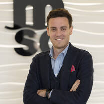 Young, smiling intern with arms crossed