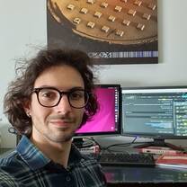 Intern smiling in front of computer screen