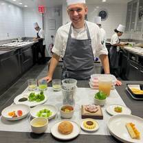 Culinary intern displaying his dishes
