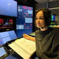 Female intern behind the scenes directing a theatrical production