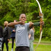 Camp USA participant practicing archery