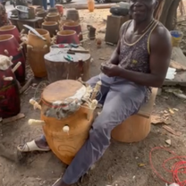 kumasi centre man making drum