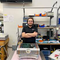 Engineering intern assembling audio equipment