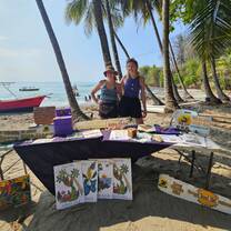 Two volunteers standing at a market stall ready to talk about the work we do at Wild Sun Rescue Center