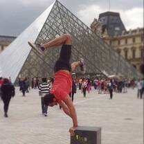 Participant doing pirouettes in from of the Louvre.
