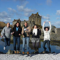 Interns jump by Eilean Donan Castle in Scotland