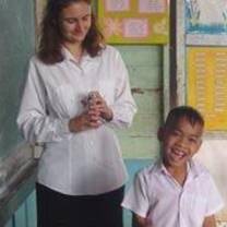 A student and teacher interact at the blackboard in Thailand