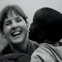 woman laughing being kissed by little boy