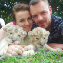 volunteers with orphaned lion cubs